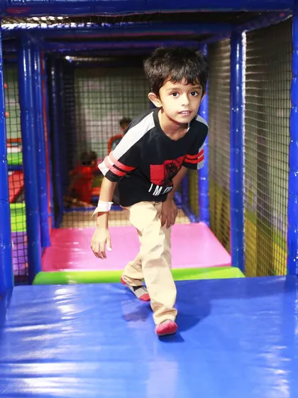 A boy confidently walks through the play maze, enjoying the freedom that comes with our unlimited play passes.
