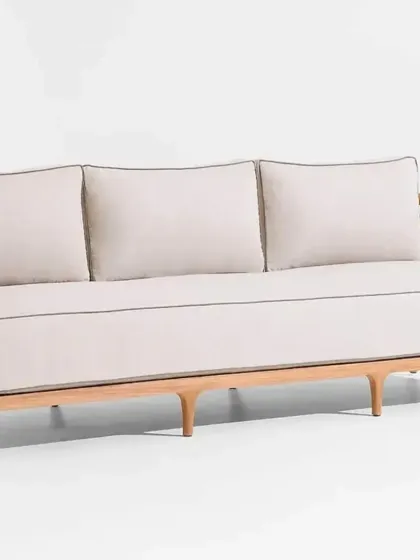 The front view of our three-seater outdoor sofa, complete with plush, piped cushions. We offer a range of outdoor-specific fabrics that are resistant to the elements.