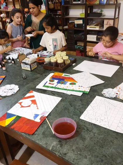 Students in my Saturday class work with drawing inks and watercolors to create intricate patterns. I provide individual attention to help each child understand the techniques and develop their skills.