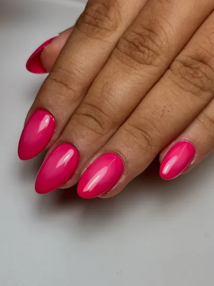 A different angle of the pink ombré nails, emphasizing the high-gloss finish and the intensity of the color.