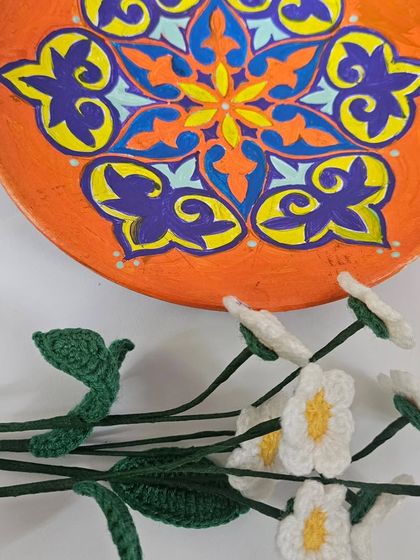 A finished hand-painted decorative wall plate with a colorful geometric mandala pattern. This piece was created for a Sip and Paint workshop, where I guide you to create your own beautiful art.