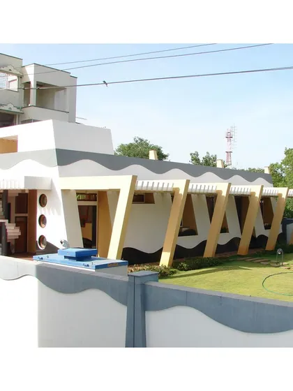 An exterior view of the CC Office from 2002, showcasing its unique self-stable tapered form. The building's elevated plinth was designed to provide an uninterrupted view of the surrounding landscape, blurring the line between inside and outside.