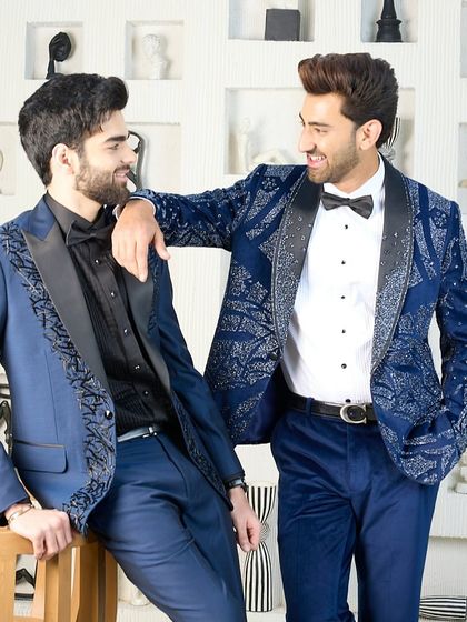 Two distinct but harmonious blue tuxedos. One features heavy silver embroidery for a bold statement, while the other has more subtle detailing, showing the range of customization I offer.