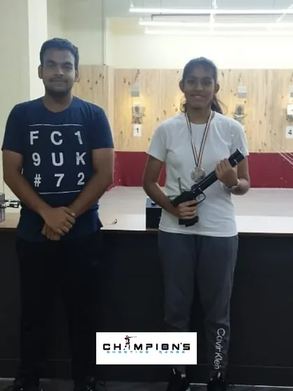 Sharvi standing with her coach after her silver medal win. This is the result of consistent practice and expert guidance.