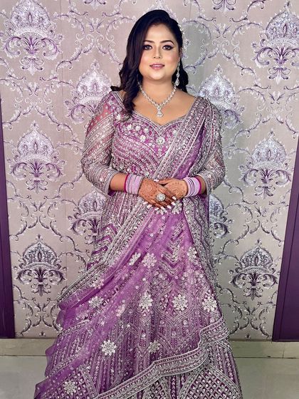The full view of this stunning lilac engagement look. The glamorous makeup perfectly complements the heavily embellished gown.