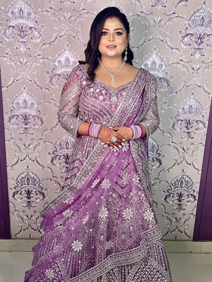 The full view of this stunning lilac engagement look. The glamorous makeup perfectly complements the heavily embellished gown.
