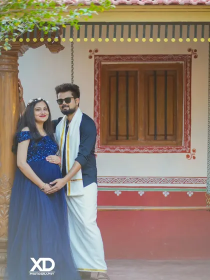 A unique blend of modern and traditional styles, with the couple posing in front of a rustic house.