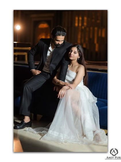 A full-length portrait showcasing the couple's impeccable style. The modern interior, combined with their elegant attire, creates a sophisticated and contemporary pre-wedding photograph.