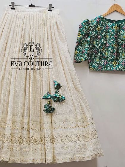 A flat-lay of the custom chikankari and printed fabric lehenga set. This design is available for both mothers and daughters, and I can customize the sizing for a perfect fit for both of you.