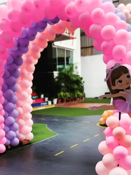 A stunning rainbow balloon arch in shades of pink and purple for a Ballerina birthday bash.