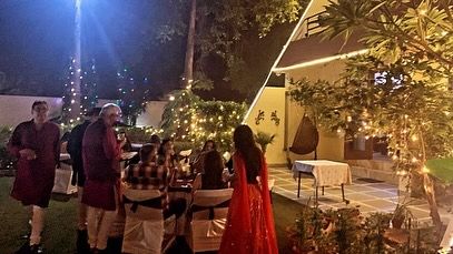 Guests mingling in the garden during a festive house party in Sainik Farms. My outdoor catering services are perfect for making the most of beautiful home spaces.