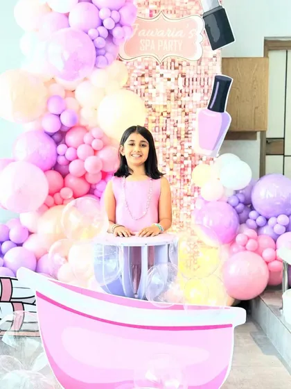 The birthday girl smiling at her spa party, perfectly framed by the elaborate balloon decor and themed props. This photo shows how our setups create a wonderful backdrop for capturing precious birthday memories.