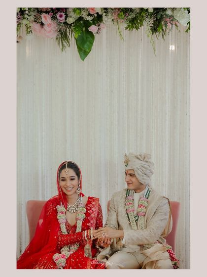 A sweet, simple portrait of the couple seated together during their wedding ceremony.