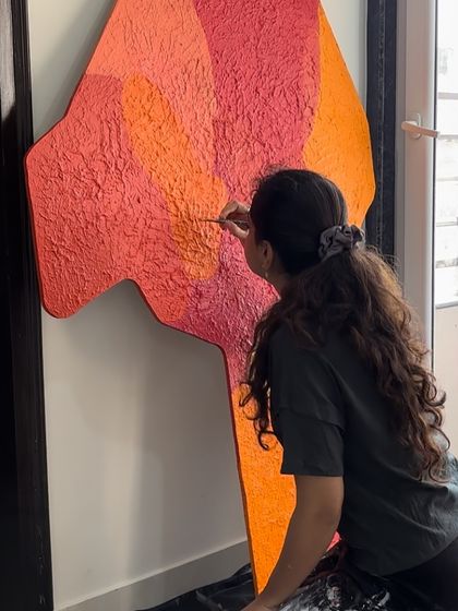 Adding the final touches to a large, textured piece in shades of orange and pink. This is where I add the fine details that bring the whole artwork together.