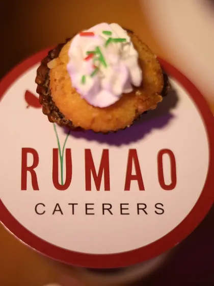 A close-up of a mini dessert bite placed on a custom "Rumao Caterers" branded coaster. This shows my attention to detail and branding for a cohesive event experience.