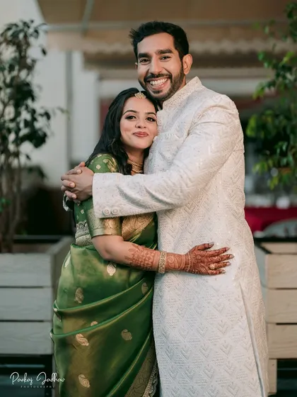 A warm embrace between Ojasi and Rutvik during their Pune engagement. This portrait showcases the beautiful green saree and the couple's comfortable, happy connection.