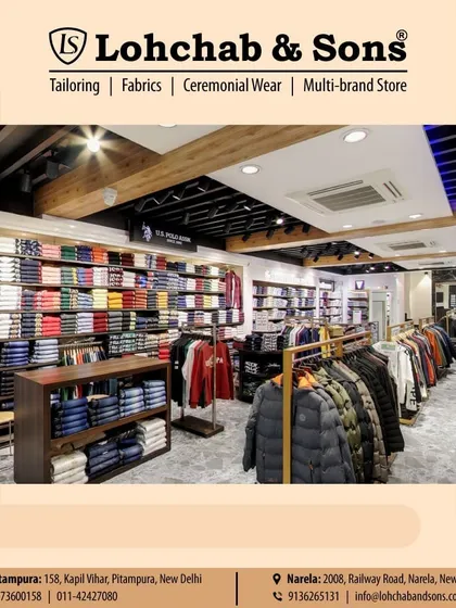 Our showroom is designed for easy browsing. Here you can see our extensive collection of ready-to-wear items, including winter jackets, vests, and a wide array of folded shirts and trousers on display.