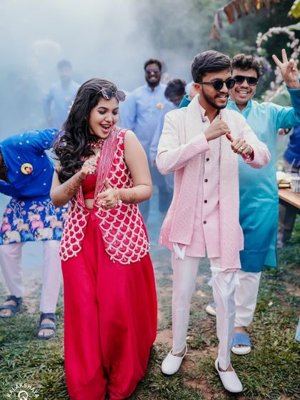 The couple dancing with friends, with smoke effects adding to the party atmosphere.