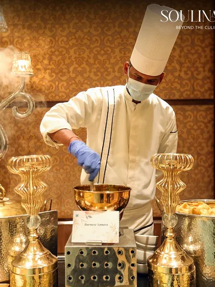A chef preparing a dish with dramatic flair using liquid nitrogen at a wedding live station. This interactive element adds a touch of theatre and excitement to the culinary experience.