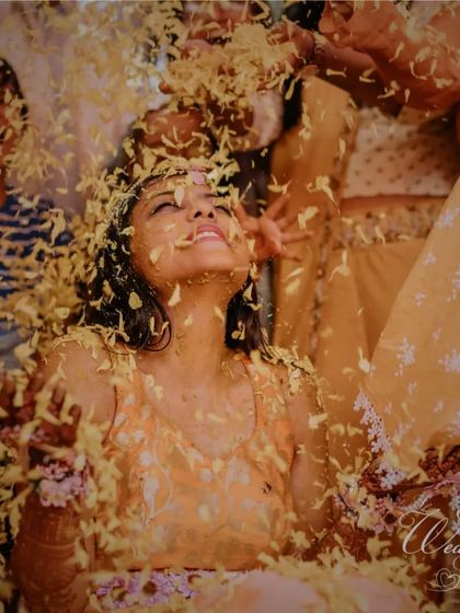 The bride looking up with joy as petals rain down on her. It's a cinematic and beautiful moment that I strive to create for every couple.