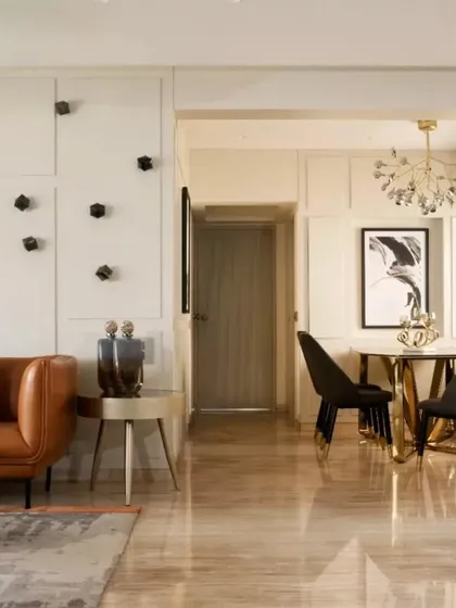 A view of the living and dining areas, showing how I use wall paneling and curated art to create a sophisticated, cohesive look. The layout connects the different zones while allowing each to have its own identity.