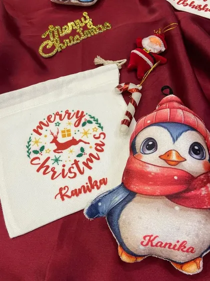 A cute penguin plush ornament and personalised goodie bag for 'Kanika'.
