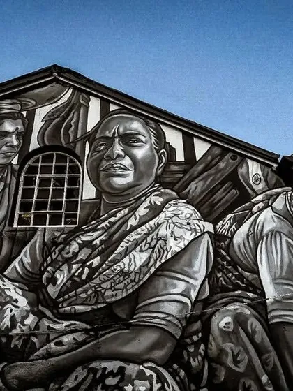 A detailed close-up of the powerful monochrome mural at Sassoon Dock. This shot focuses on the expressive faces of the Koli fisherwomen, capturing their hard work and determination.