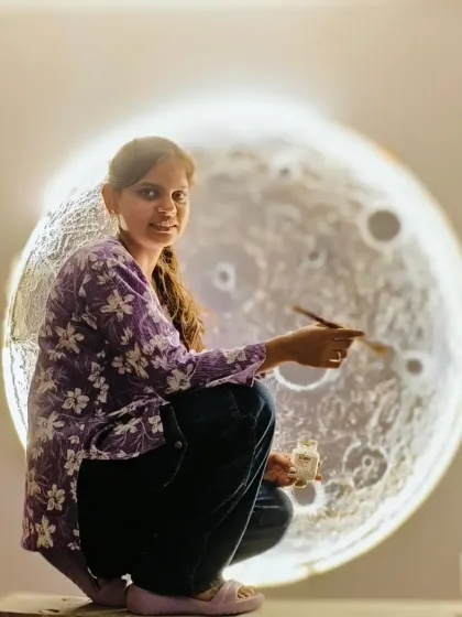 A talented artist and student putting the finishing touches on a moon art piece in my studio.