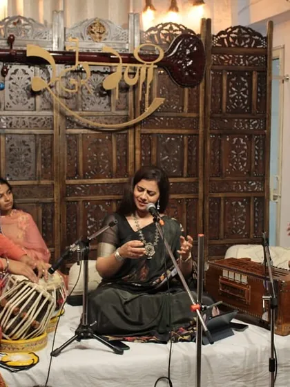 The synergy between artists is key to a successful performance. Here, the vocal artist interacts with the tabla and harmonium players, creating a seamless musical dialogue during a live mehfil.