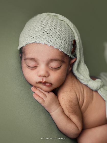 A slightly different angle of this sleepy pose, showing the soft texture of the hat and the baby's peaceful expression.