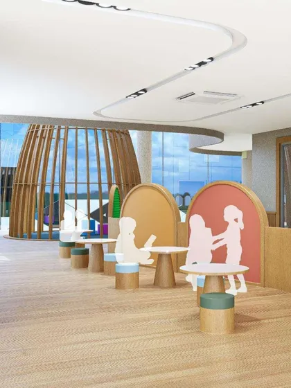 A render of a play and learning area at Mother's Pet School. The design uses child-sized furniture and playful partitions to create distinct zones for different activities while maintaining an open feel.