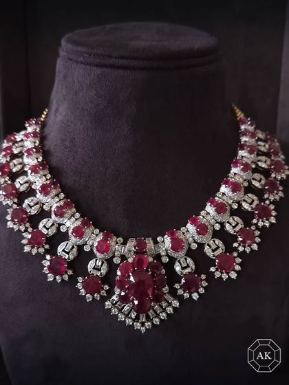 A masterpiece for the grandest moments. This elaborate bridal neckpiece is handcrafted in 18K gold with custom-cut round rubies, baguettes, and round diamonds, a true investment in legacy.
