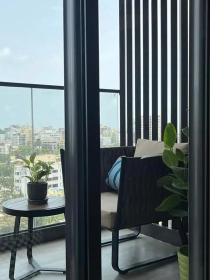 Even a small balcony can be a luxurious retreat. I designed this space with comfortable seating and vertical louvers for privacy, creating a perfect spot to enjoy the city view.