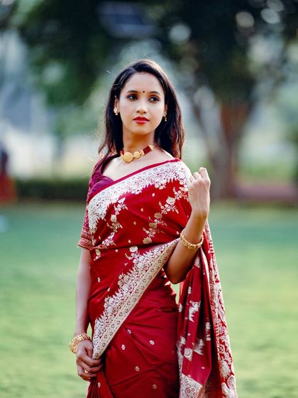 A portrait capturing a graceful pose that shows off the elegance of the saree drape.