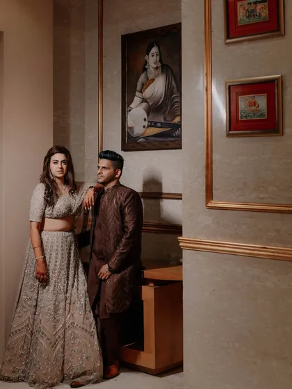 A regal portrait of a couple at their reception. The classic decor and their elegant attire create a sense of timeless sophistication.