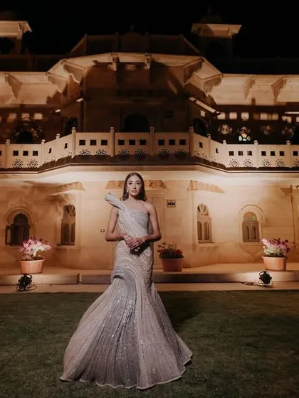 The bride looking absolutely breathtaking in her reception gown against the illuminated backdrop of the heritage hotel.