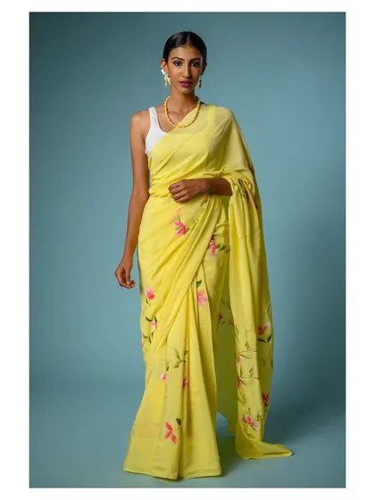 A full-length view that captures the entire drape of the yellow saree, essential for e-commerce product pages.