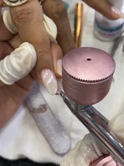 A close-up of the airbrushing process, showing how I create a soft, blended effect on the nail.