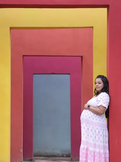 Make a statement with our vibrant, multi-colored geometric wall, a modern and artistic backdrop for any photoshoot. It's an excellent choice for maternity pictures, adding a pop of color and a unique architectural element to your portraits.