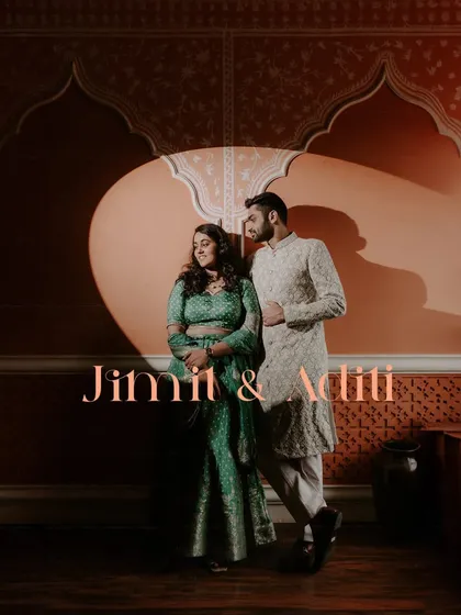 A dramatic couple portrait using a spotlight against a beautifully patterned wall, creating a theatrical feel for this pre-wedding event.
