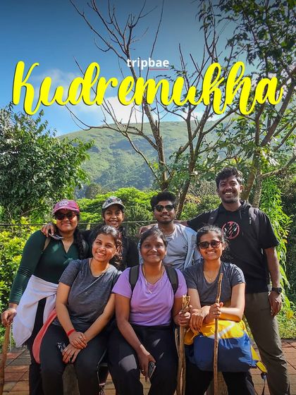 A small group of trekkers taking a break on the Kudremukh trail, with their trekking poles.