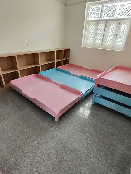 A closer look at the nap cots. Sourcing the right furniture is a key part of a school project, and these were chosen for their safety, durability, and space-saving design.