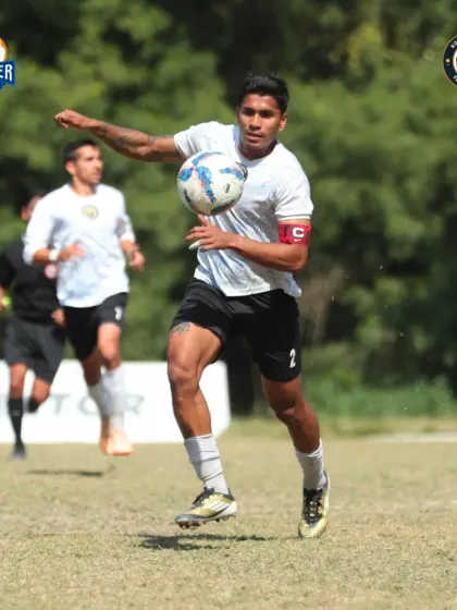Our captain on the charge, carrying the ball forward with strength and purpose.
