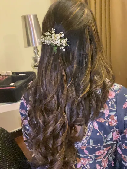 A simple yet beautiful half-up hairstyle with soft curls. I added a small sprig of baby's breath for a touch of romantic elegance.
