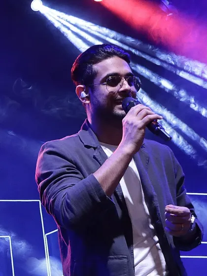 A candid shot of the singer interacting with the crowd, captured in a moment of pure energy. Our events are designed to be engaging and interactive.