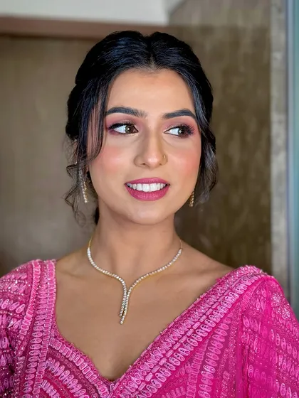 A close-up of the makeup, featuring soft pink tones on the eyes and cheeks for a monochromatic and sophisticated look.