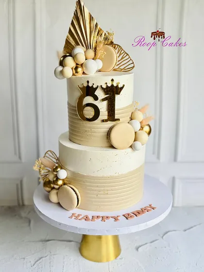 A cake as elegant as the journey it celebrates. This two-tier cake for a 61st birthday features sophisticated beige and gold tones.