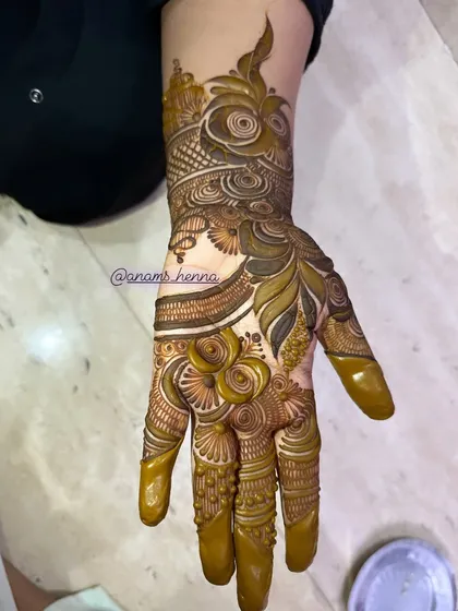 A full-hand bridal design with a beautiful mix of swirls, florals, and geometric patterns. The fingers are fully covered for a traditional look.