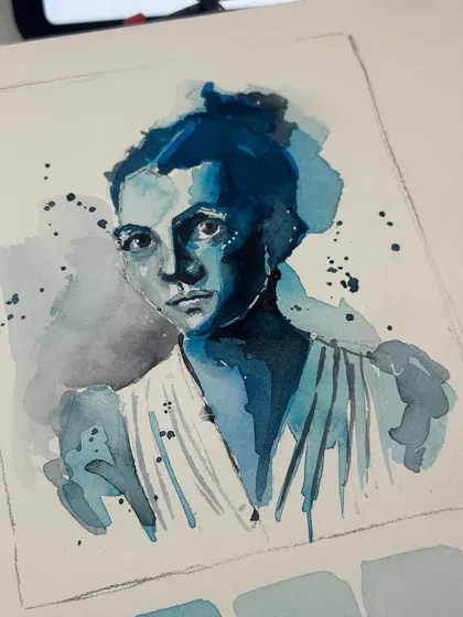 The finished monochromatic blue watercolour portrait, showing the delicate washes and splatters that add texture and emotion.
