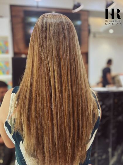 We love creating sun-kissed dimension with our balayage techniques. This client's hair looks naturally lightened and full of life, with straight styling that emphasizes the smooth, healthy finish.